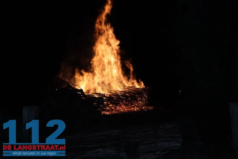 Metershoge vlammen bij flinke brand in berg boomstammen Sprang-Capelle 112 De Langstraat