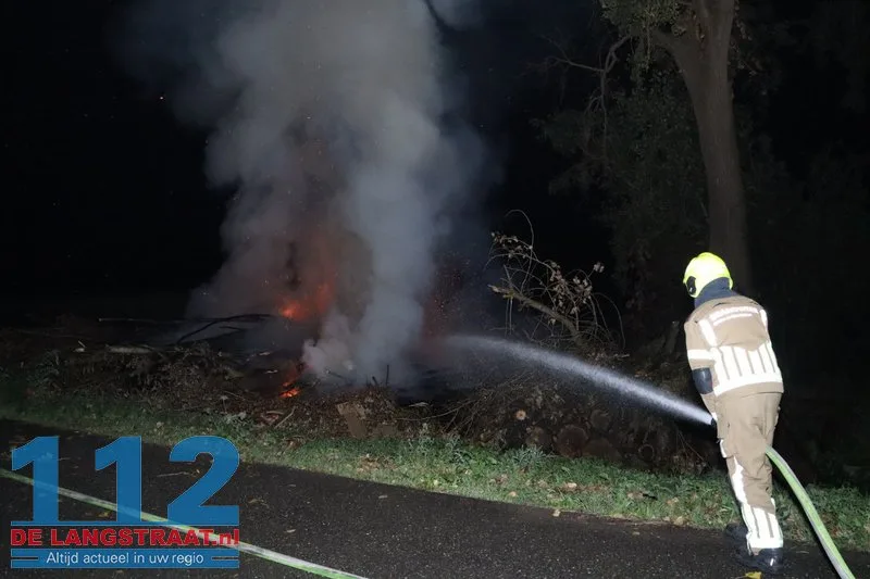 Metershoge vlammen bij flinke brand in berg boomstammen Sprang-Capelle 112 De Langstraat