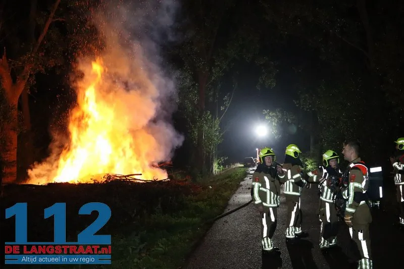 Metershoge vlammen bij flinke brand in berg boomstammen Sprang-Capelle 112 De Langstraat